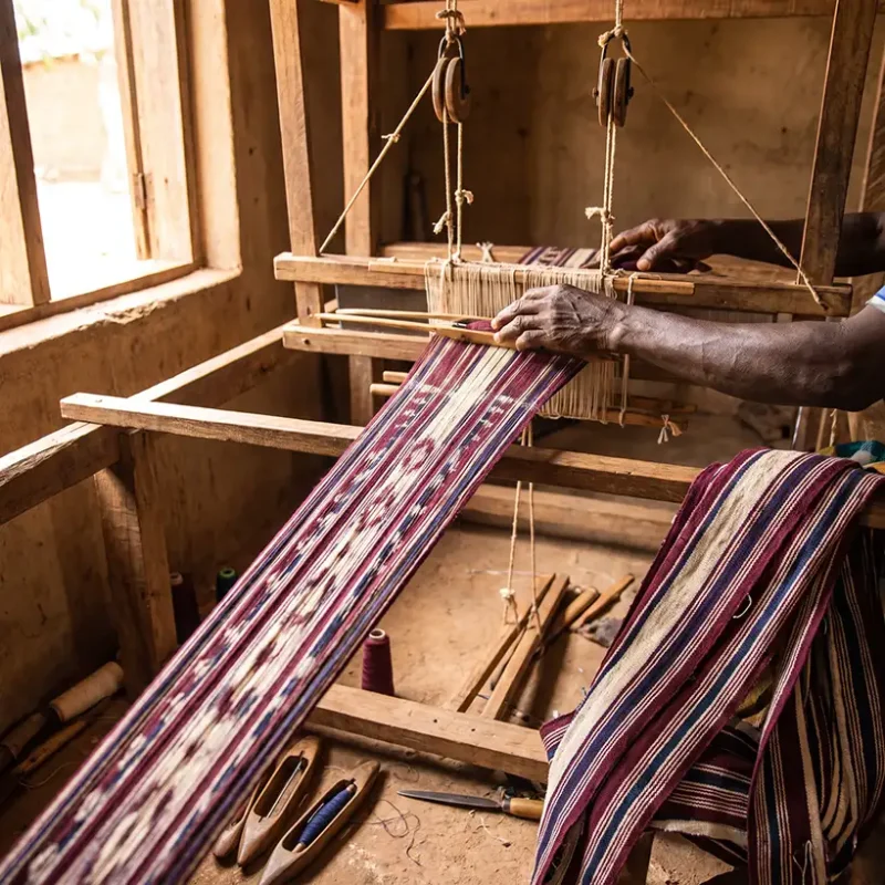Narrow-strip weaving on a traditional loom producing panels for Mandinka cloth