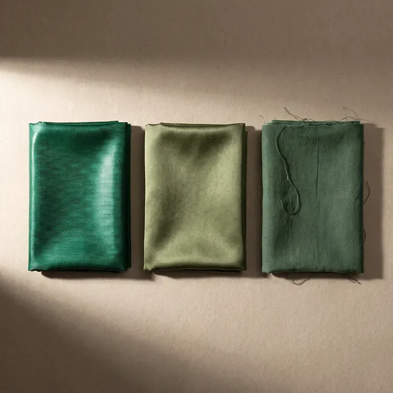 Three grades of bazin compared side by side showing differences in sheen, weight and weave