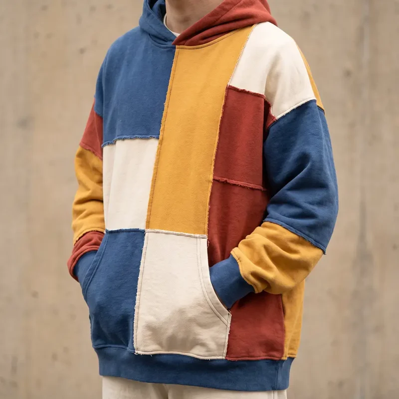 Modern streetwear hoodie with njaxass-inspired patchwork panels in a contemporary cut