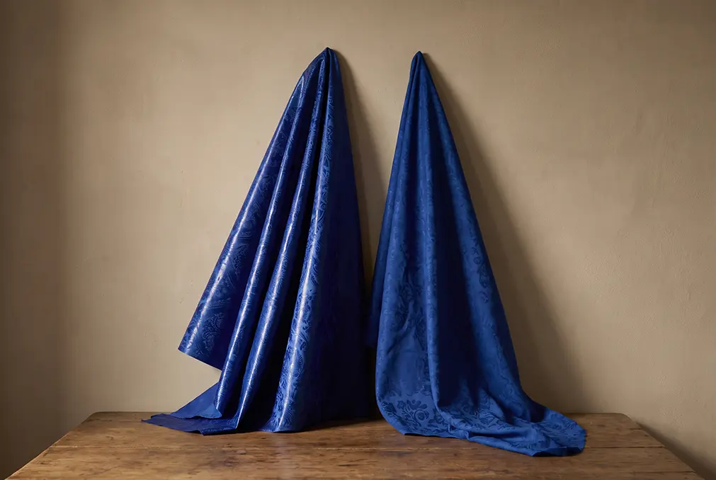 Genuine bazin riche compared with a soft printed imitation, showing the difference in sheen and stiffness